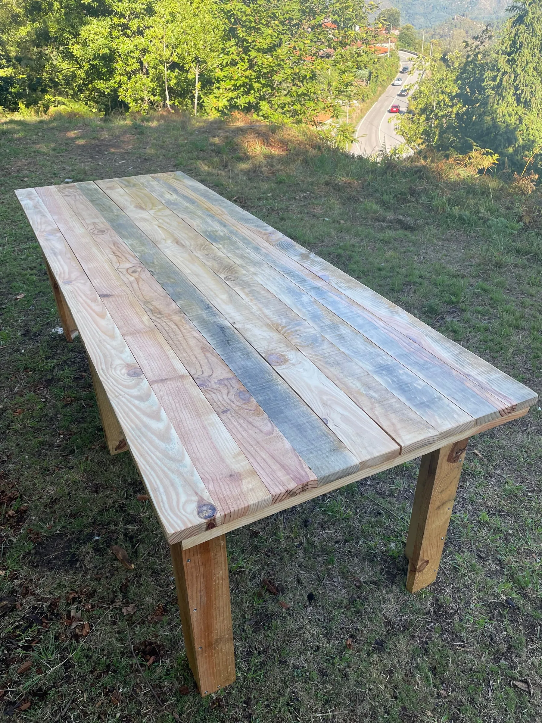 A long outdoor wooden table on grass